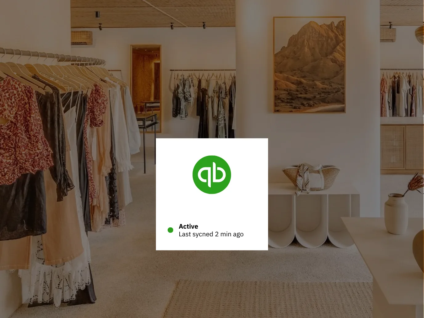 QuickBooks connection card showing an active status and a recent sync, over a clothing boutique interior
