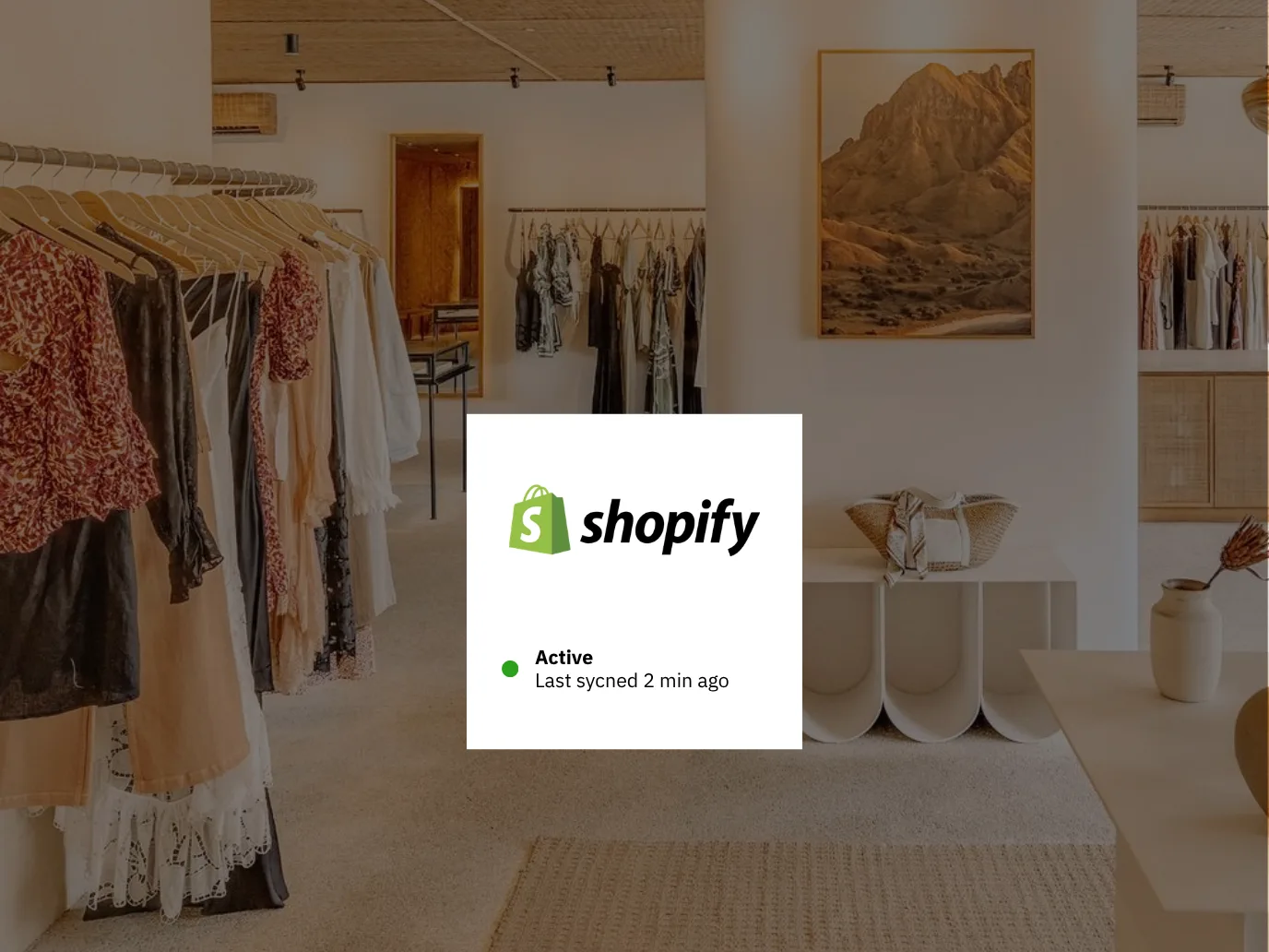 Shopify connection card showing an active status and a recent sync, over a clothing boutique interior